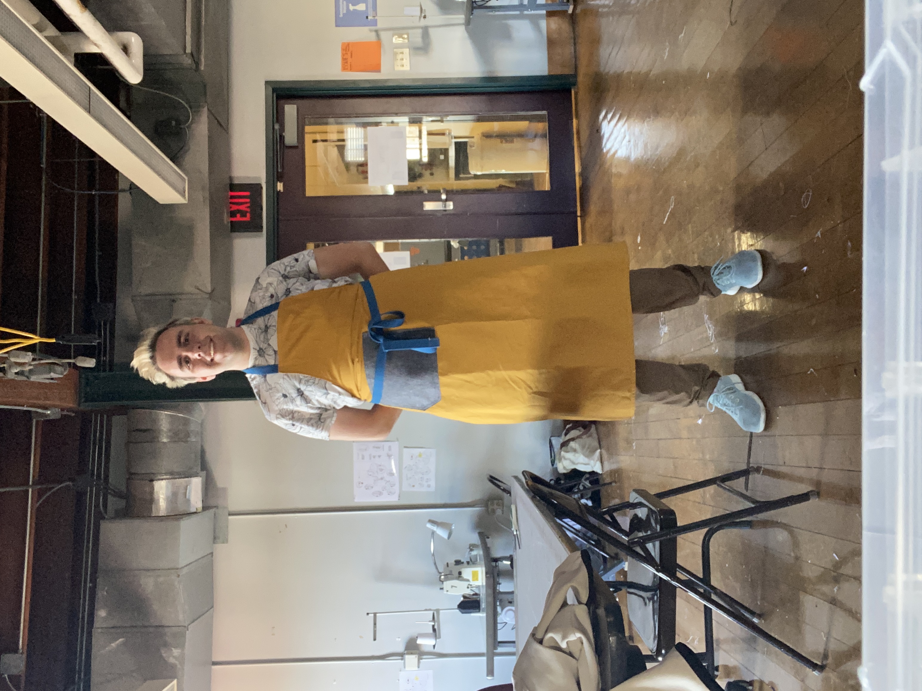 Wearing my custom apron while repairing machines in the Soft Goods Room at RISD.